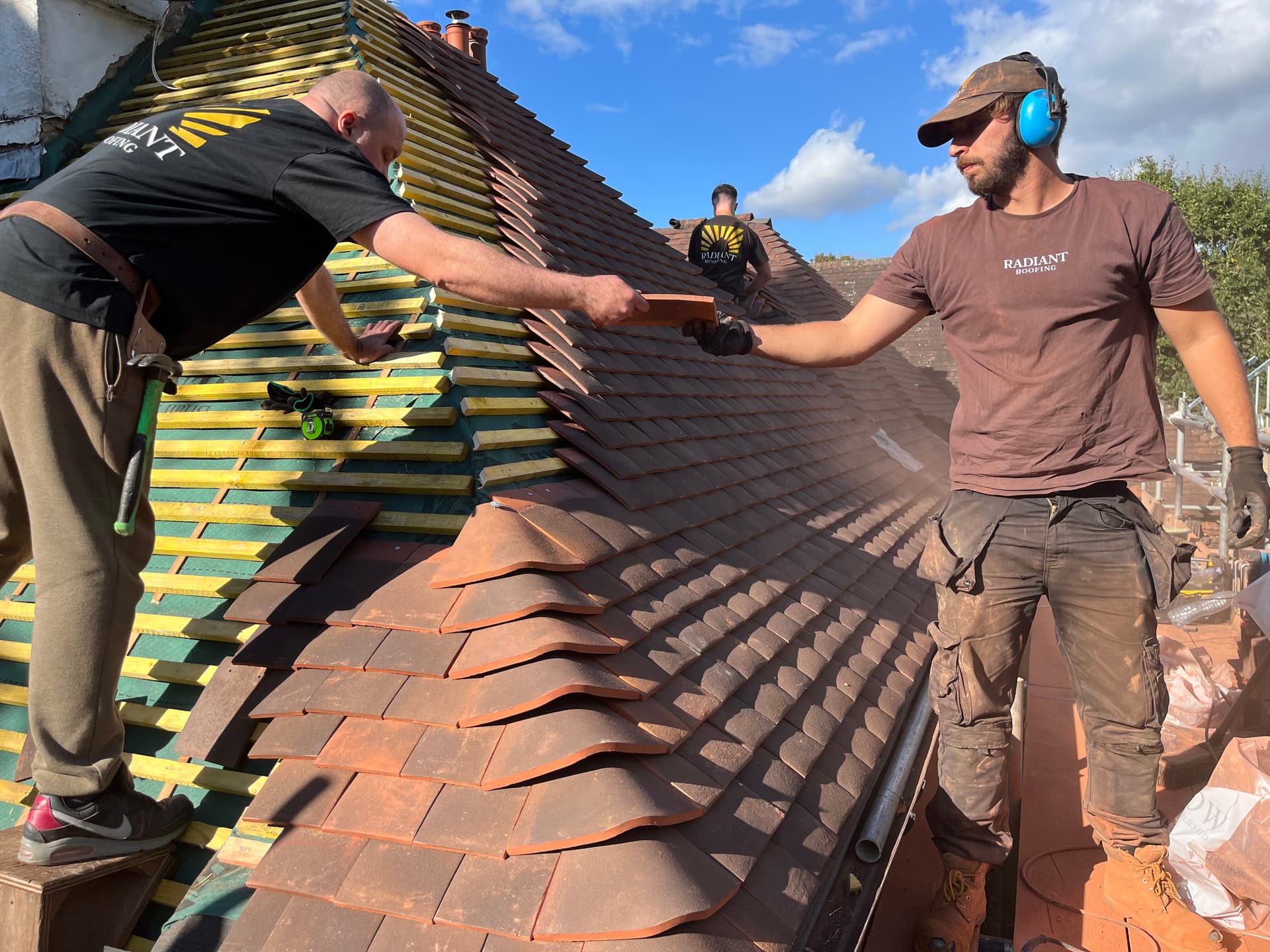 Radiant Roofing team installing a roof