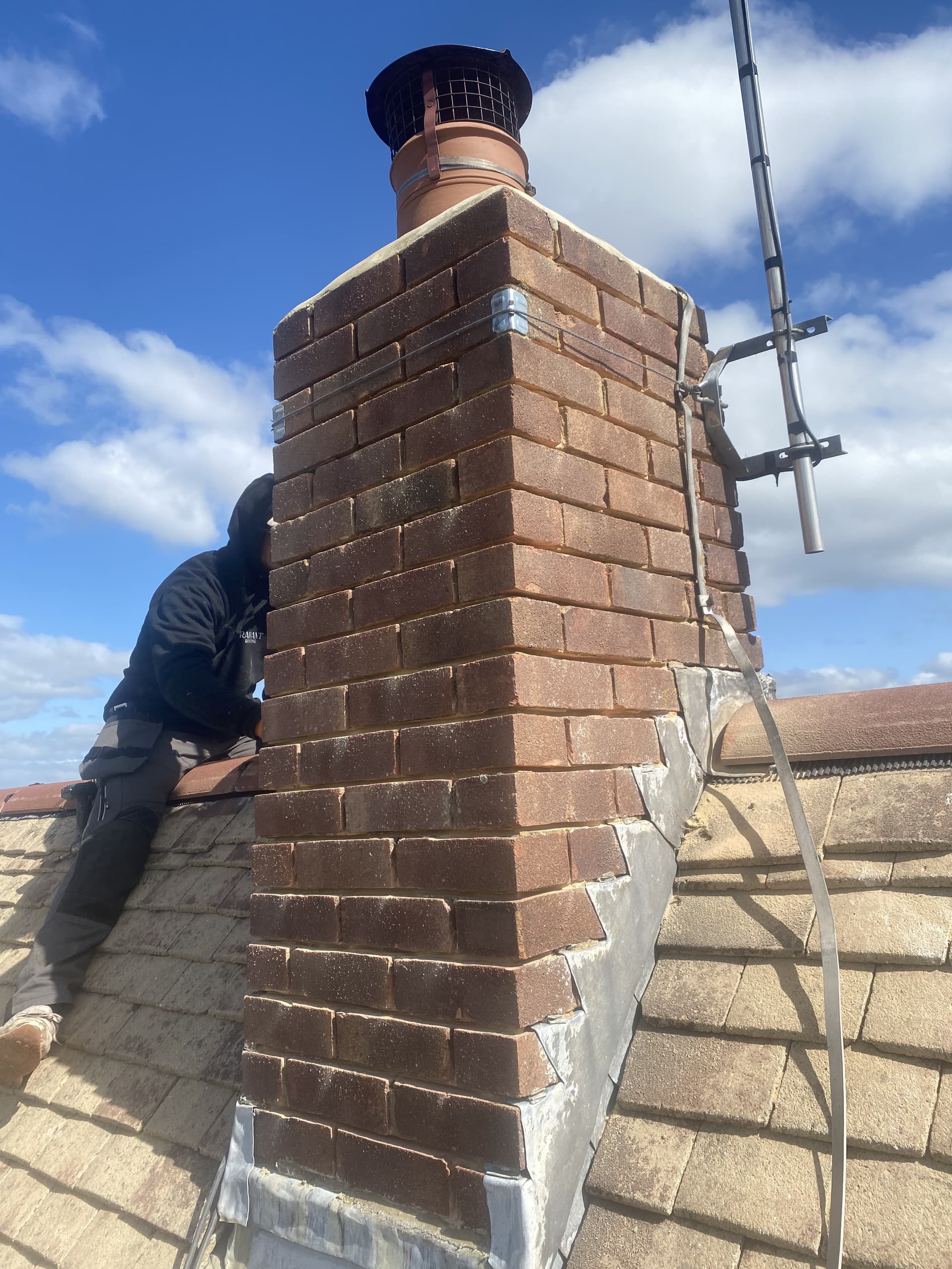 Worker installing chimney lead flashing