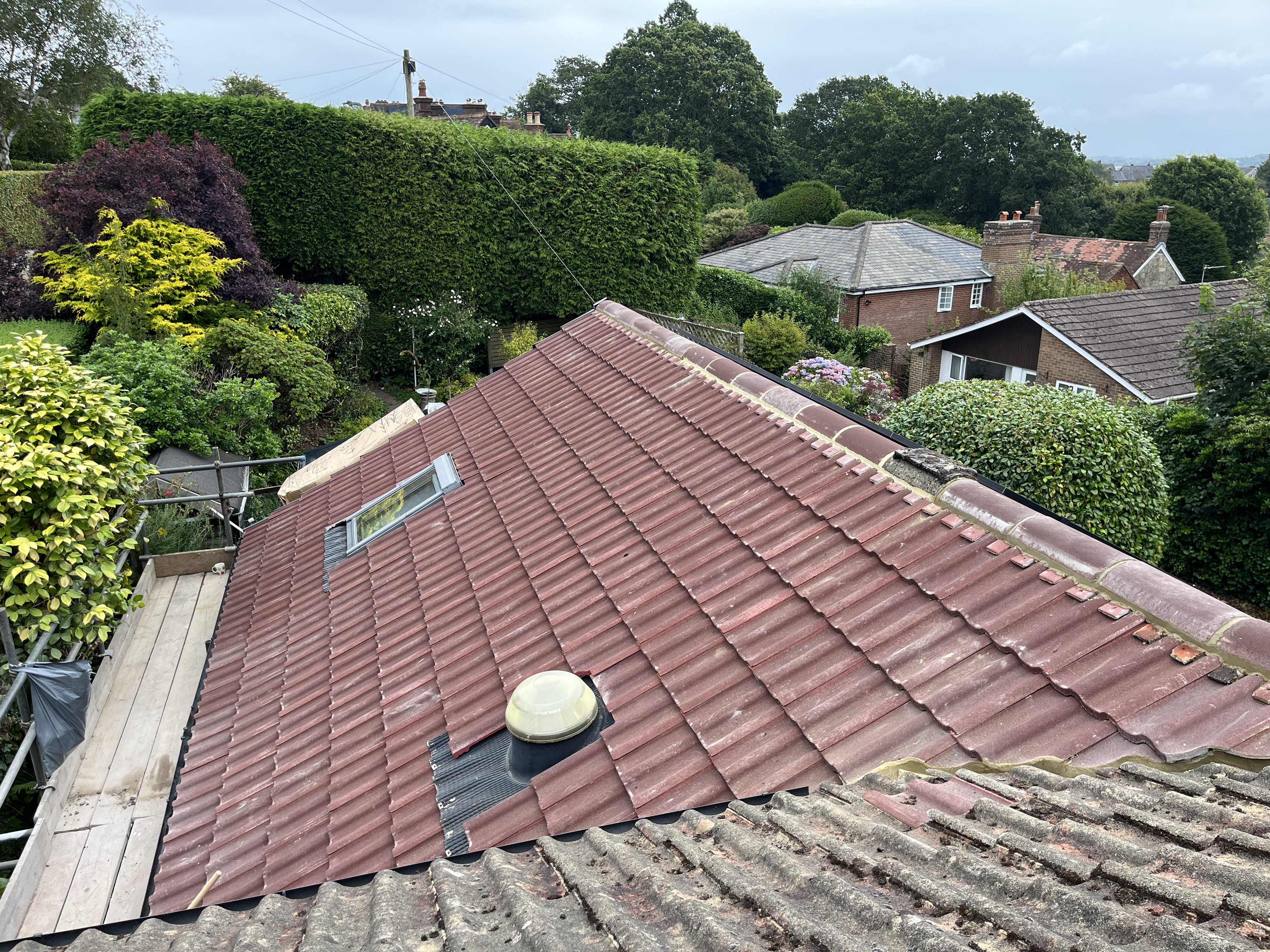 New concrete tile roof with skylight and garden