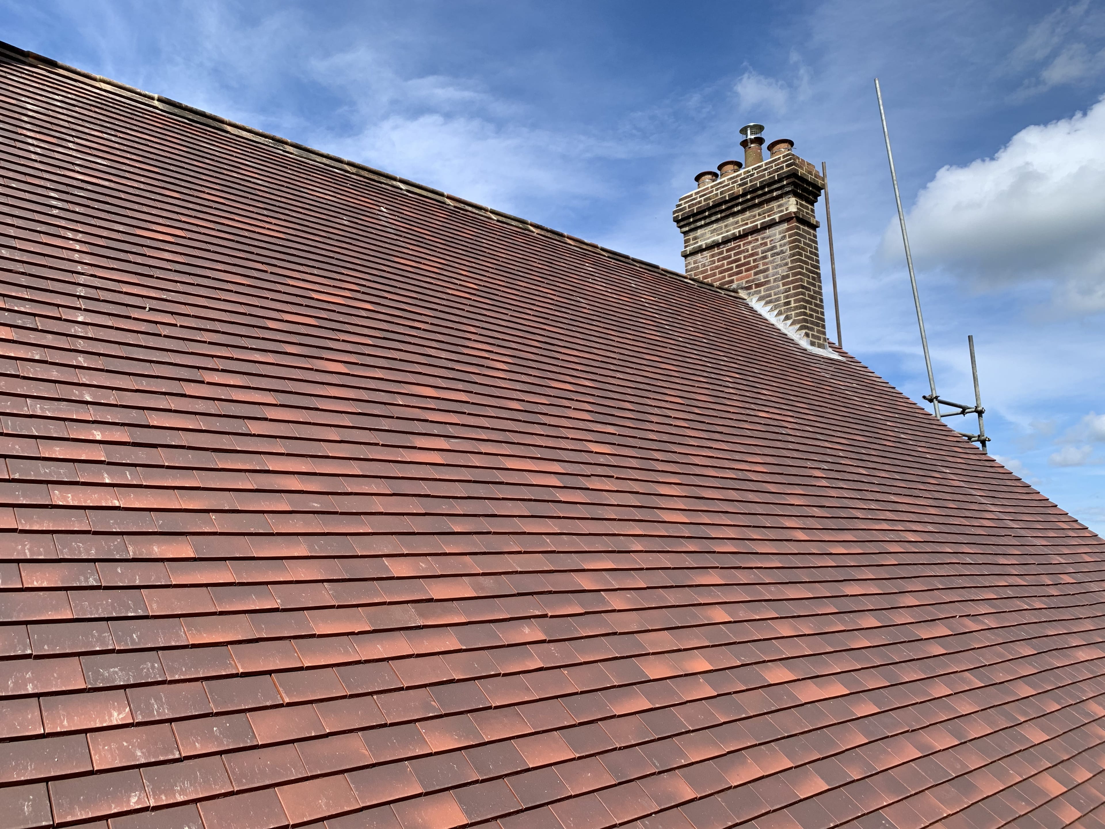 New red clay tile roof with chimney